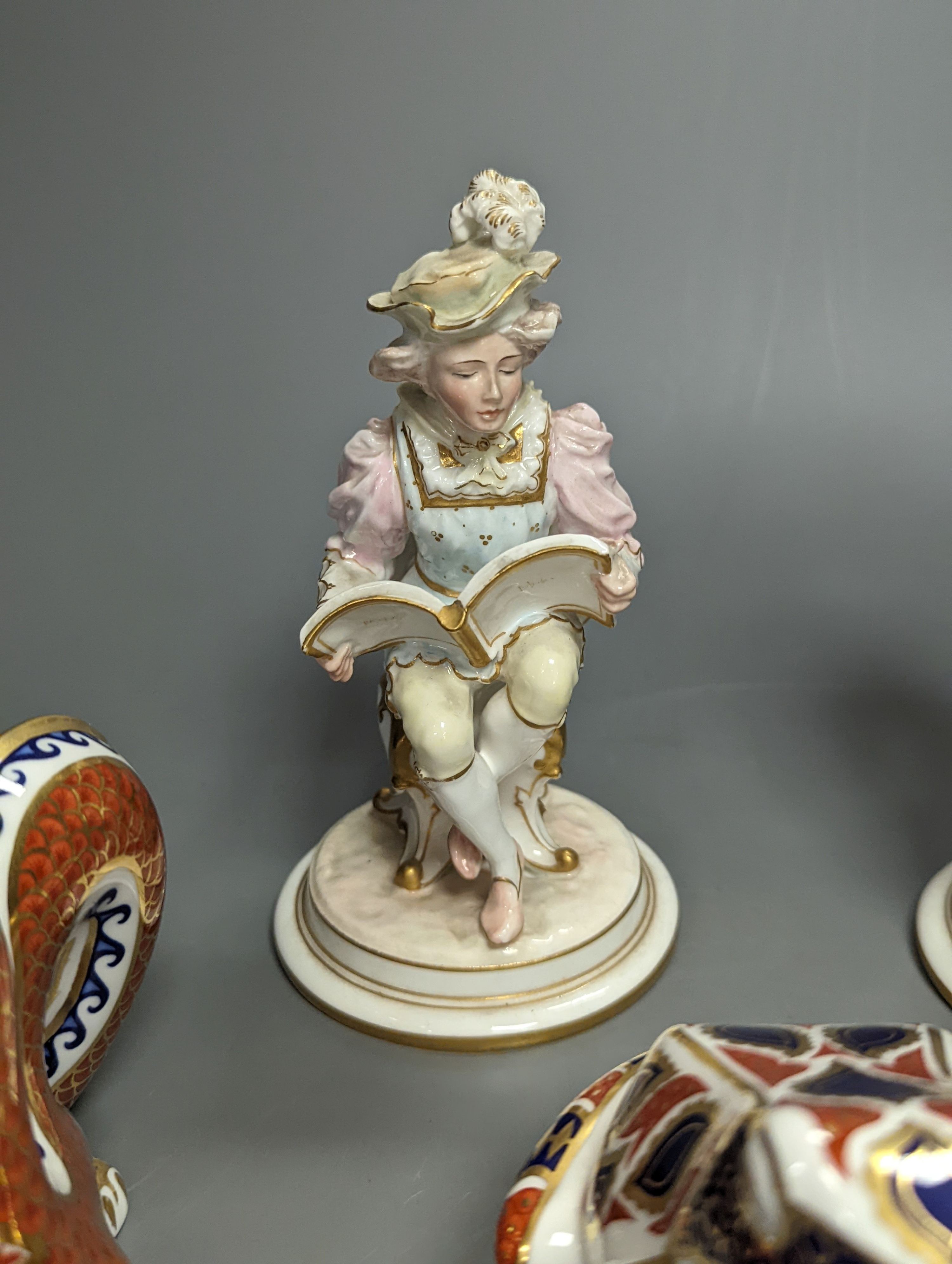 A pair of Royal Crown Derby figures of musicians, c.1905, 15cm, two similar animal paperweights and a Latticino glass slipper, tallest being the dragon 11cm